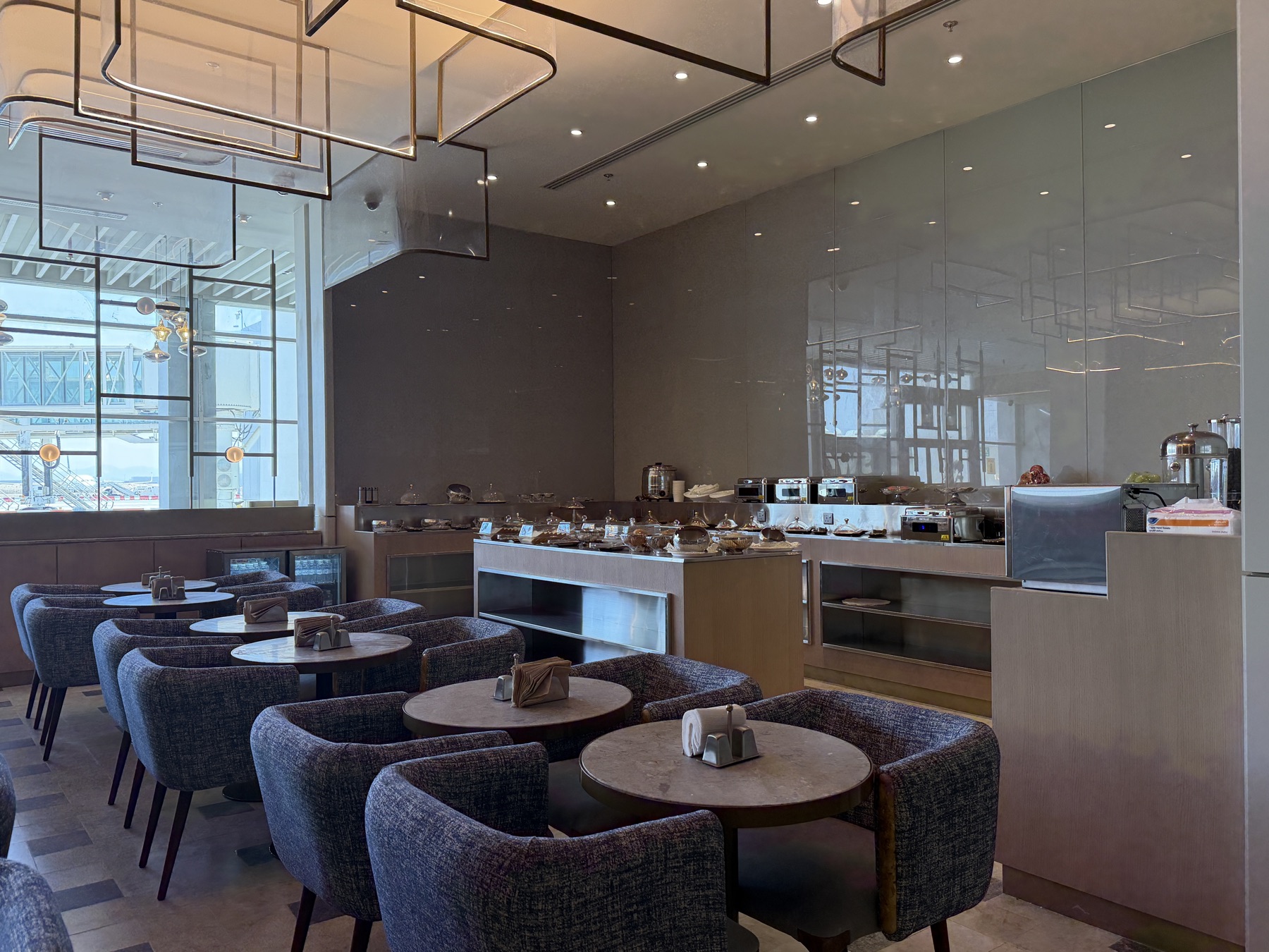 Dining tables under sculpted ceiling