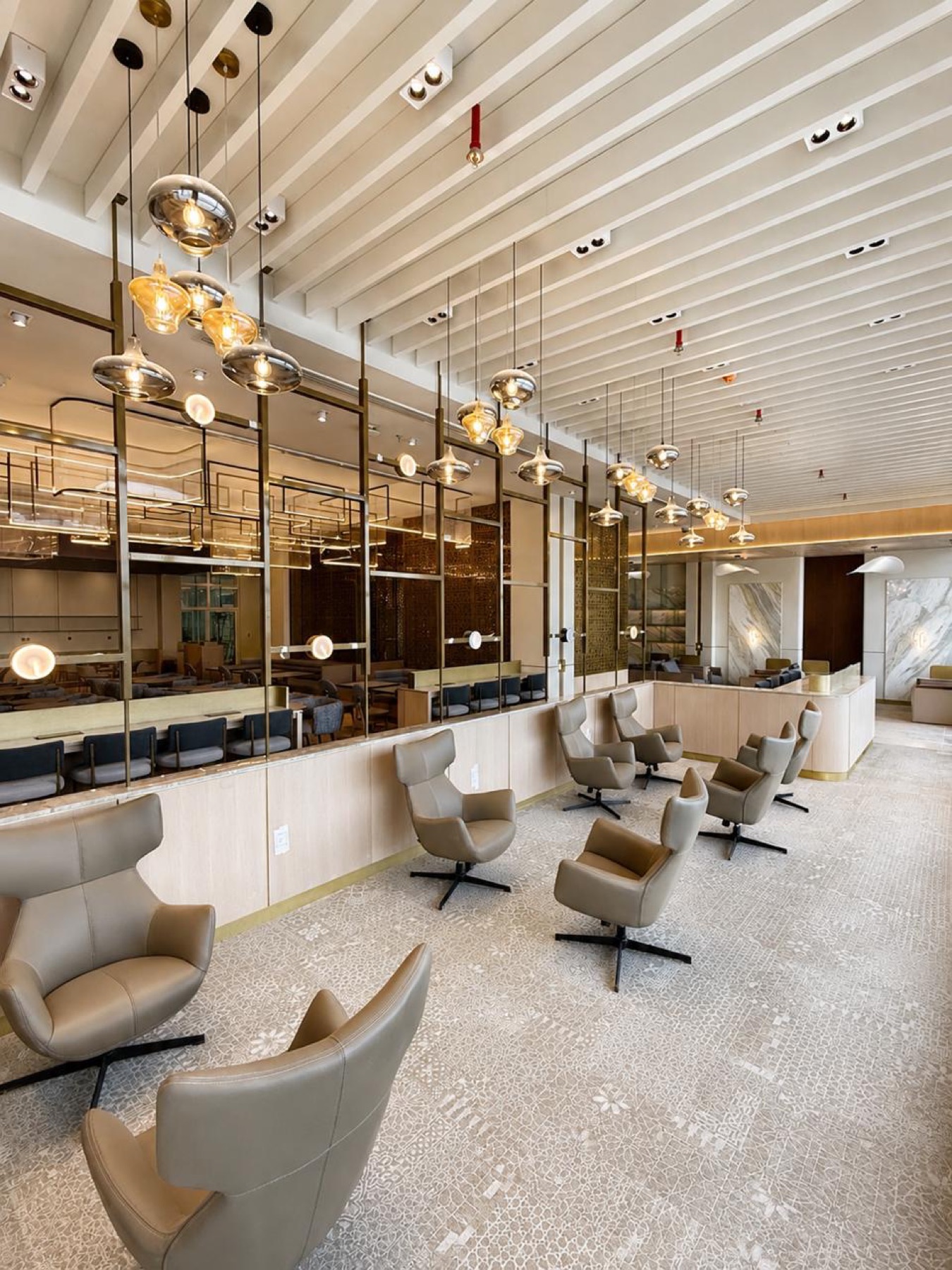 Wingback chairs and amber pendants