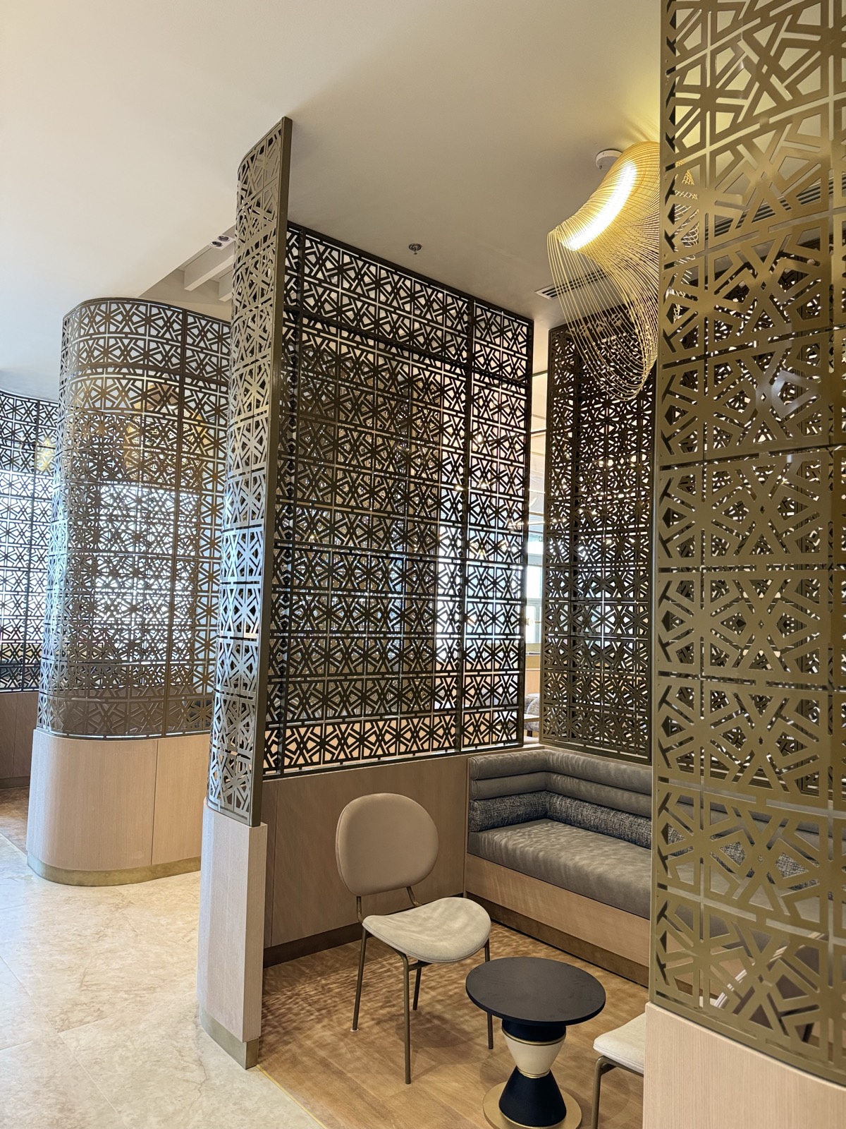 Quiet seating alcoves behind brass screens
